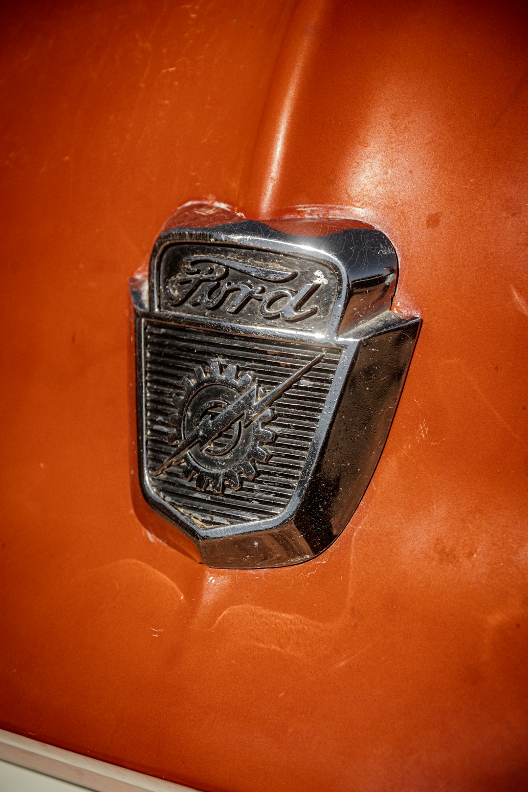 silver and black emblem on orange surface