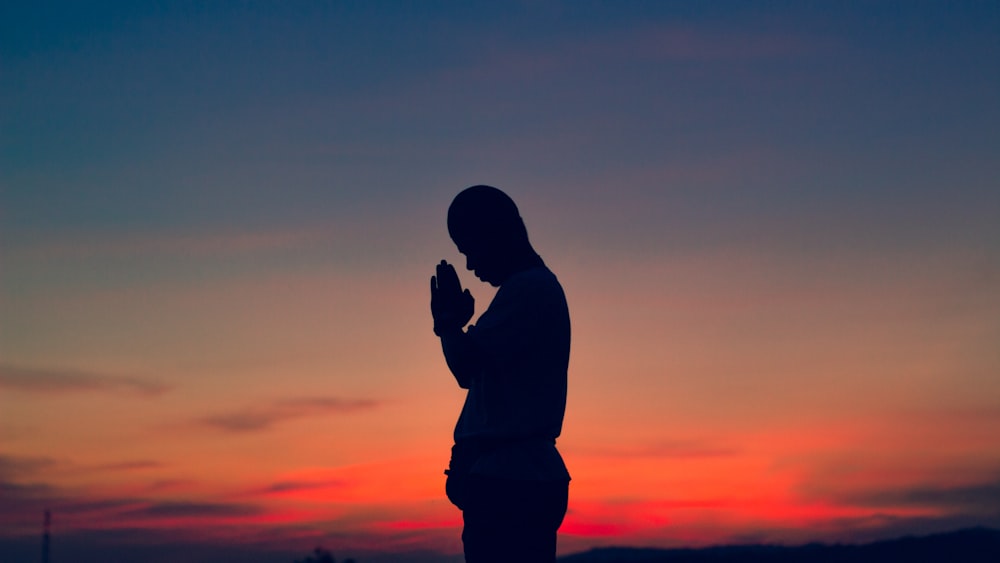 silhouette of man during sunset