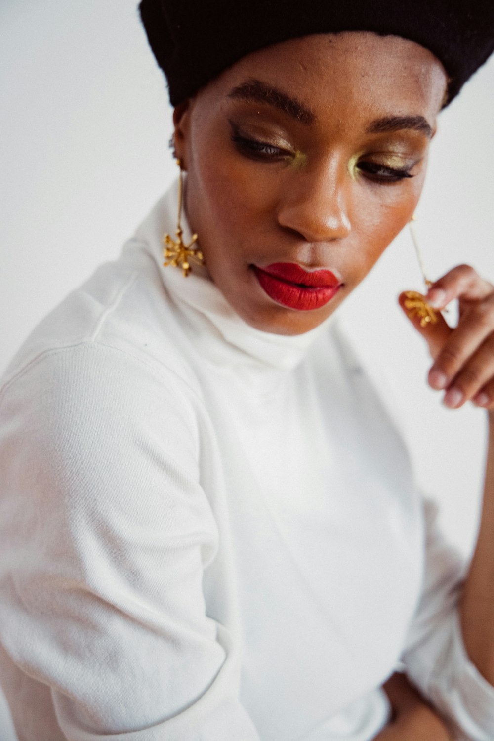 woman in white long sleeve shirt wearing gold ring