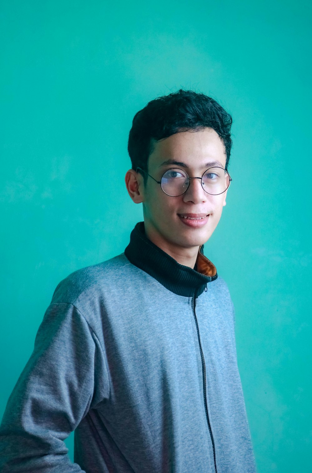 man in gray hoodie wearing black framed eyeglasses