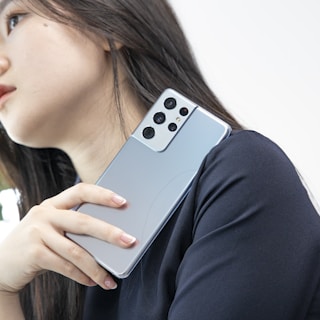 A stylish photo of a model holding a phone, ready to connect.