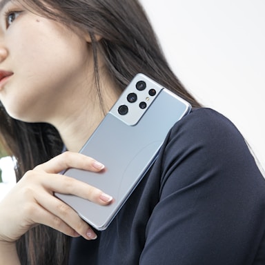 A stylish photo of a model holding a phone, ready to connect.