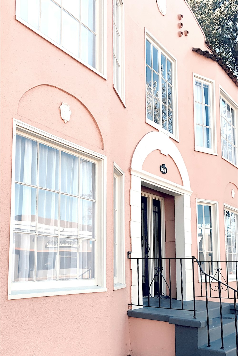 red concrete building with black metal window grills