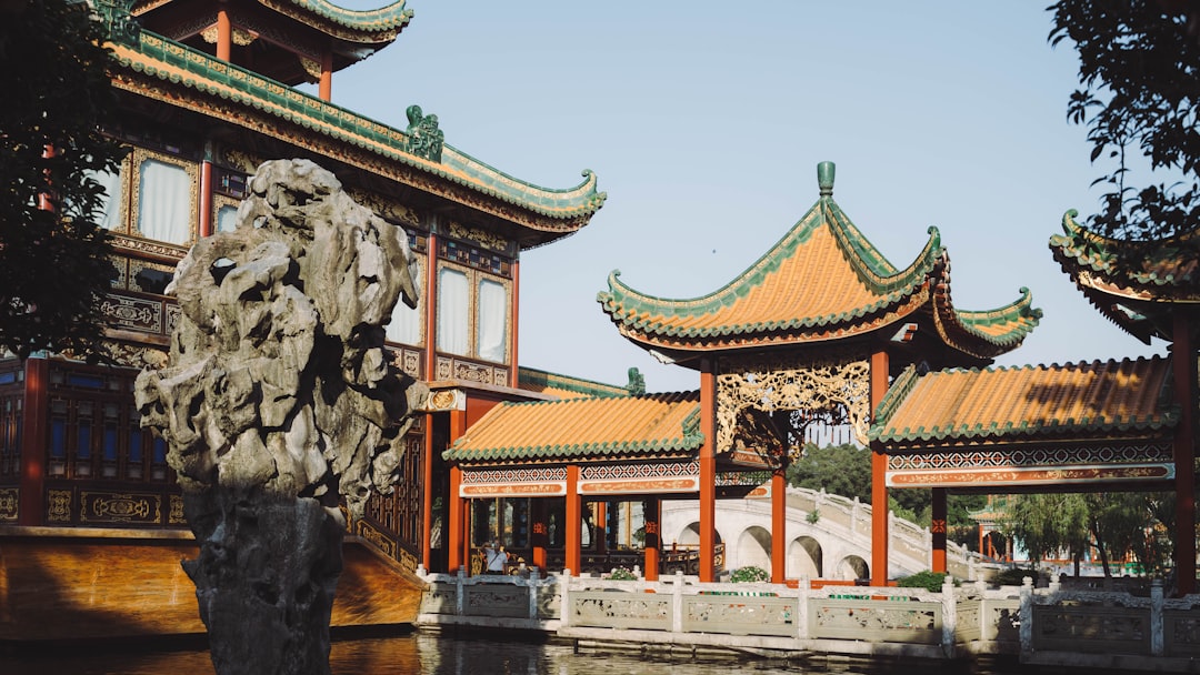 red and brown temple near body of water