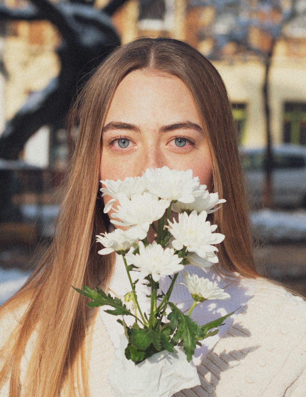 woman in white shirt holding white flower