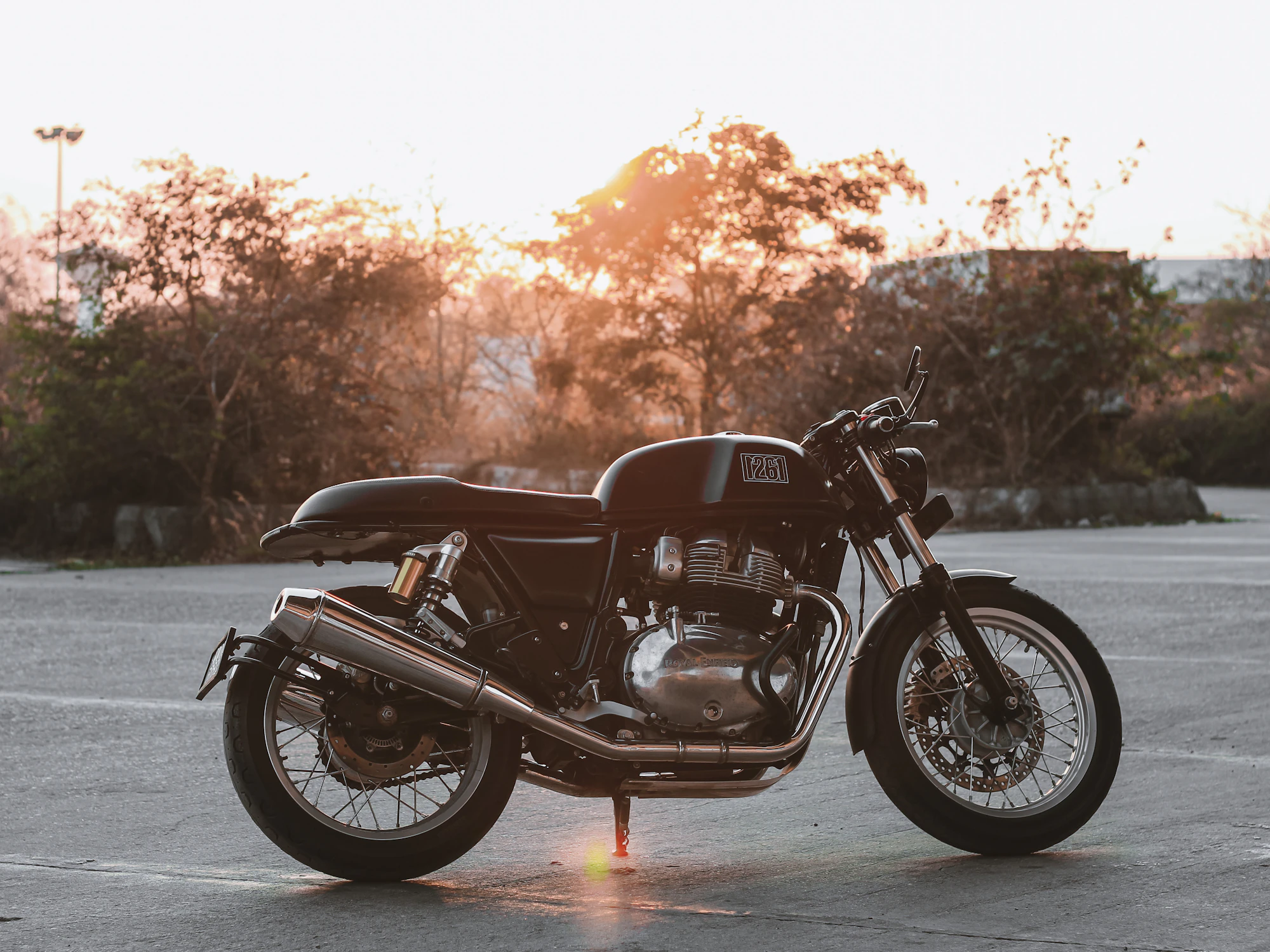 Cafe racer motorcycle in profile at golden hour