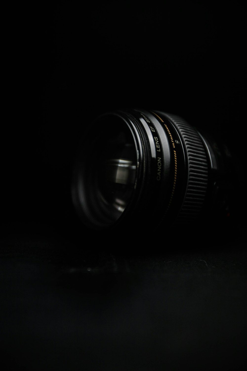 black camera lens on black surface