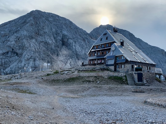 brown wooden house near mountain during daytime in Triglav National Park Slovenia