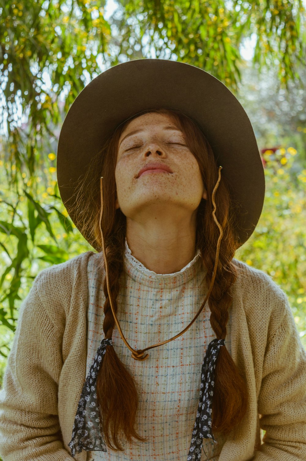 woman in brown hat and brown cardigan