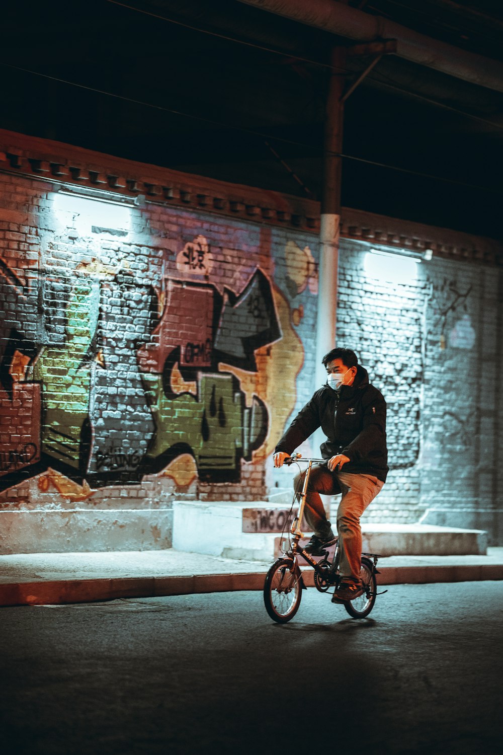 man in black jacket riding bicycle