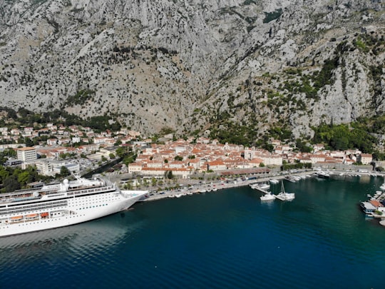 white cruise ship on body of water near mountain during daytime in Kampana Tower Montenegro