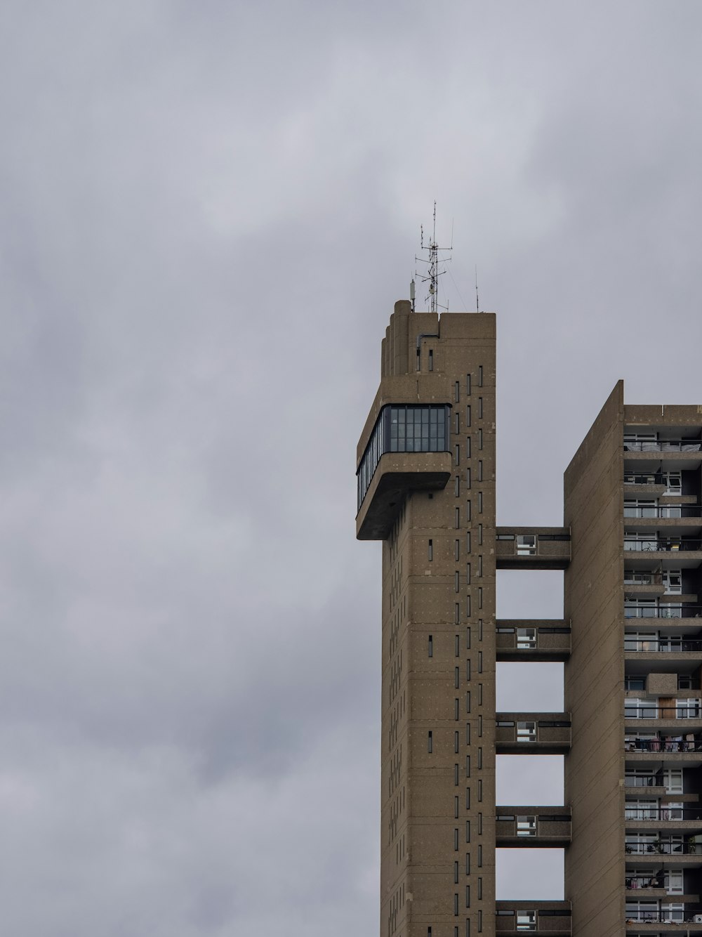 brown concrete building under white clouds during daytime