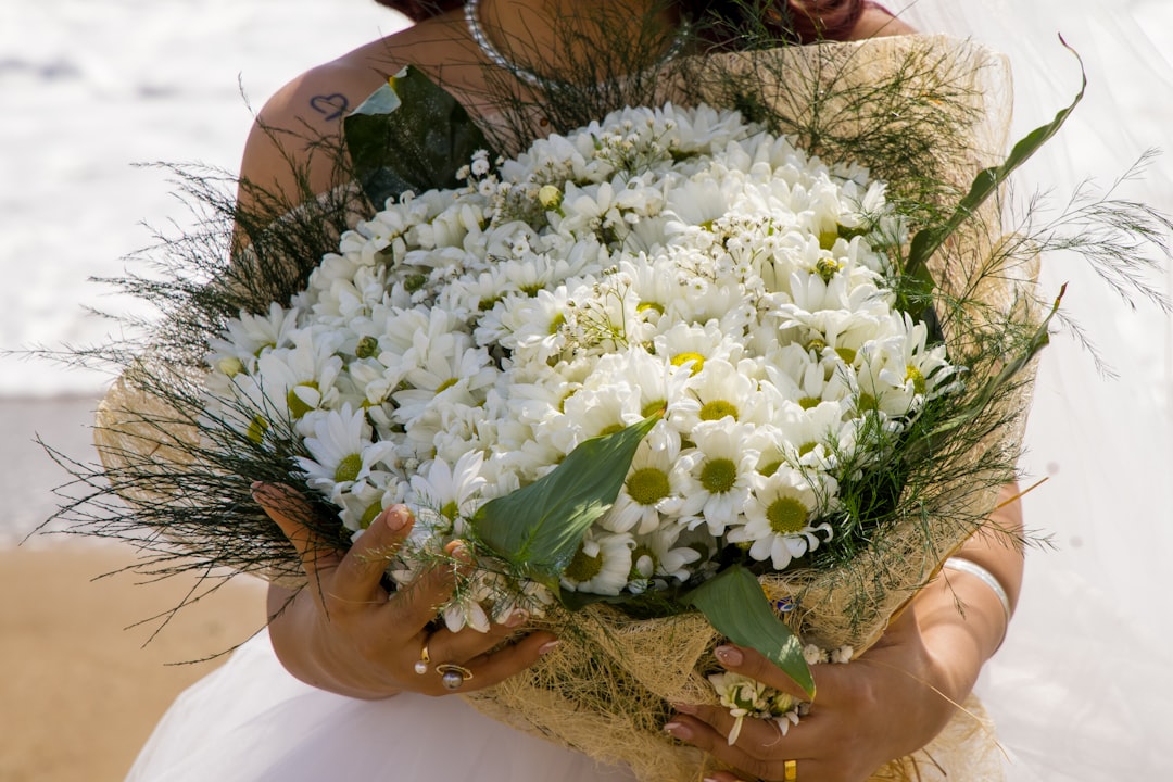 woman holding white flower bouquet