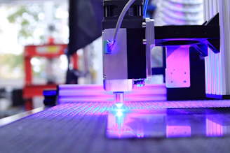 A sleek CNC machine operating in a bright, modern industrial workshop.