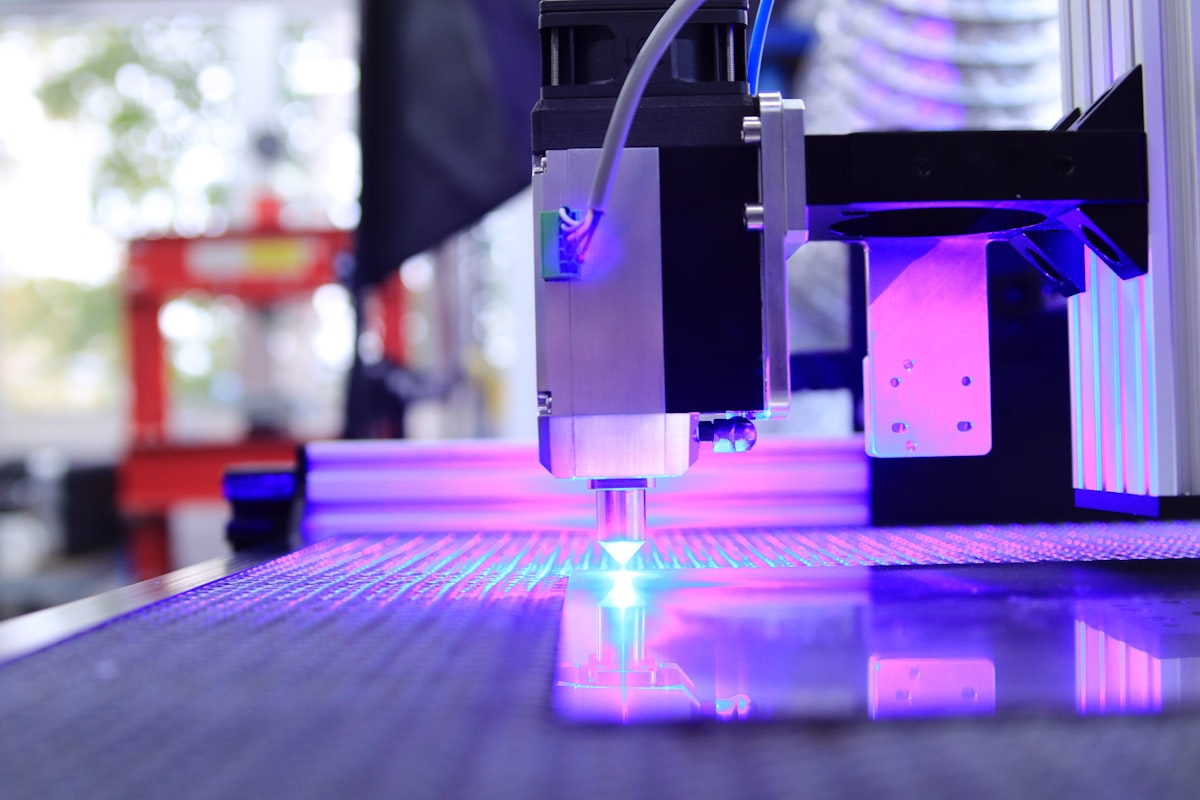 Laser cutter in operation producing sparks while cutting metal sheet