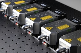 Close-up of advanced laser equipment with sleek design and gold detailing.