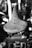 Close-up image of a leather bicycle saddle, displaying the Brooks branding with metallic rivets. The focus is on the saddle, while the background is blurred.