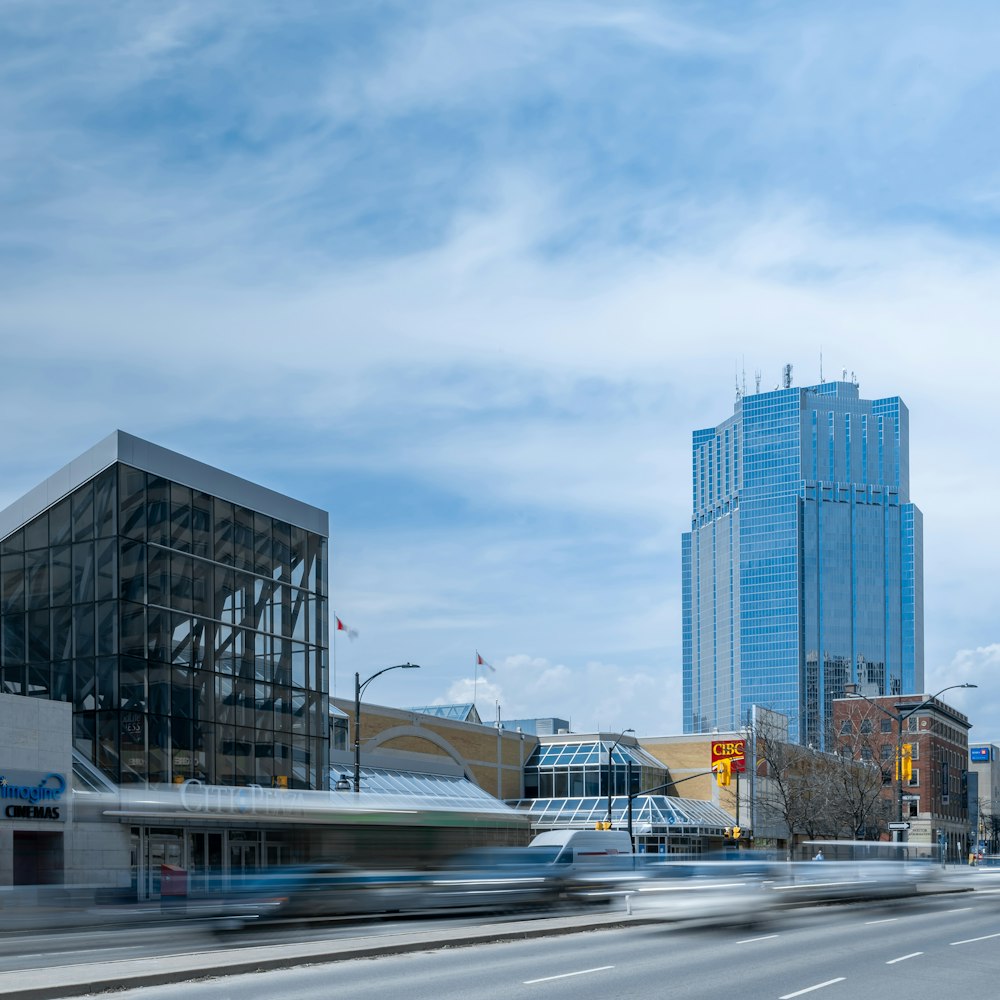 cars on road near high rise buildings during daytime