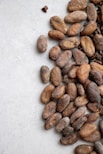 brown almond nuts on white surface