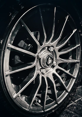 Close-up of mach1's custom alloy wheels spinning on the track.