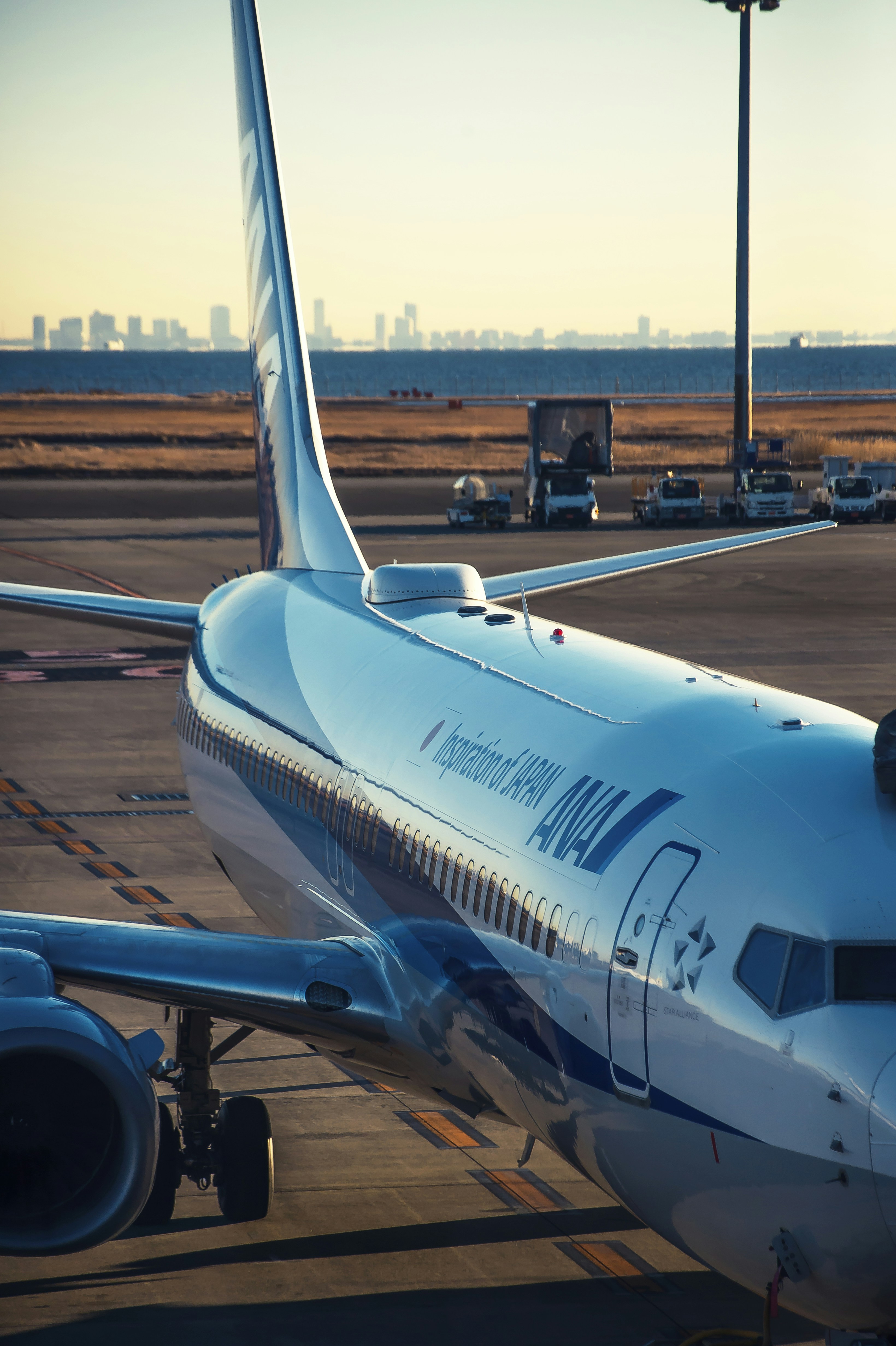 white and blue airplane on airport during daytime