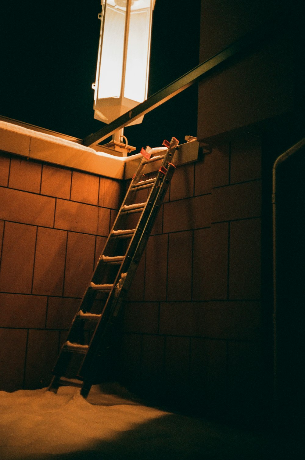 brown brick wall with black metal staircase