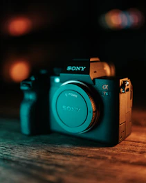 A sleek Sony FX6 camera set up in a dimly lit studio with amber accent lighting.