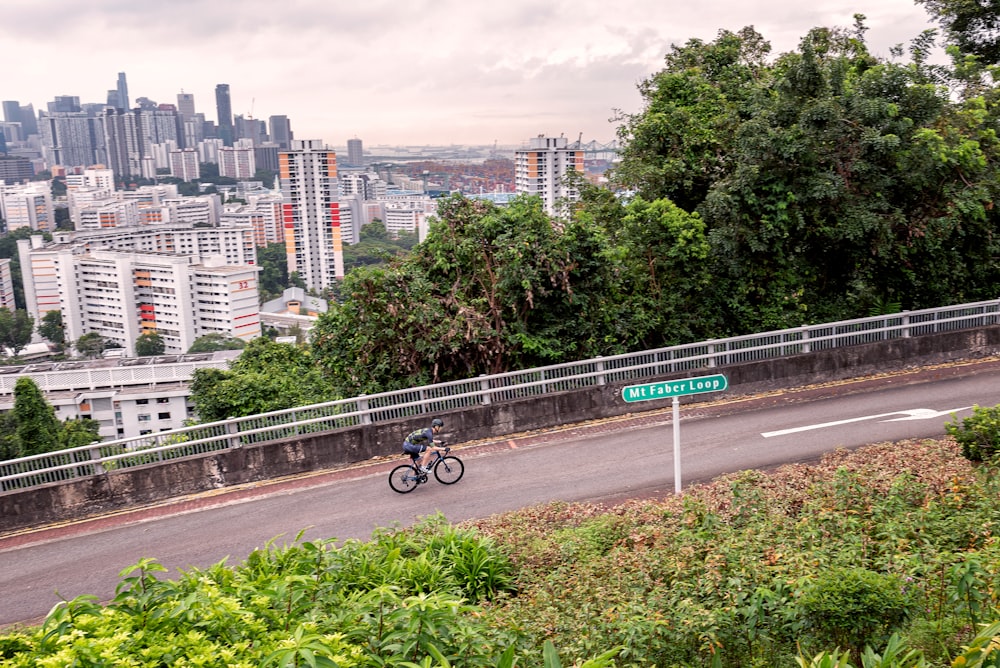 person riding bicycle on road during daytime