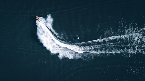 white and black boat on sea during daytime