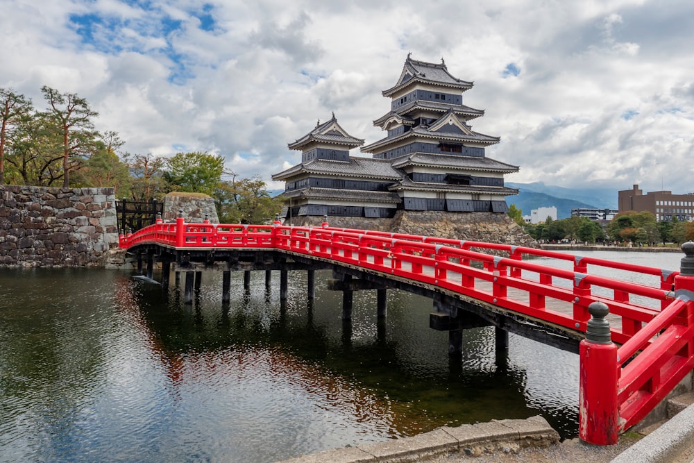 red and white wooden bridge over river