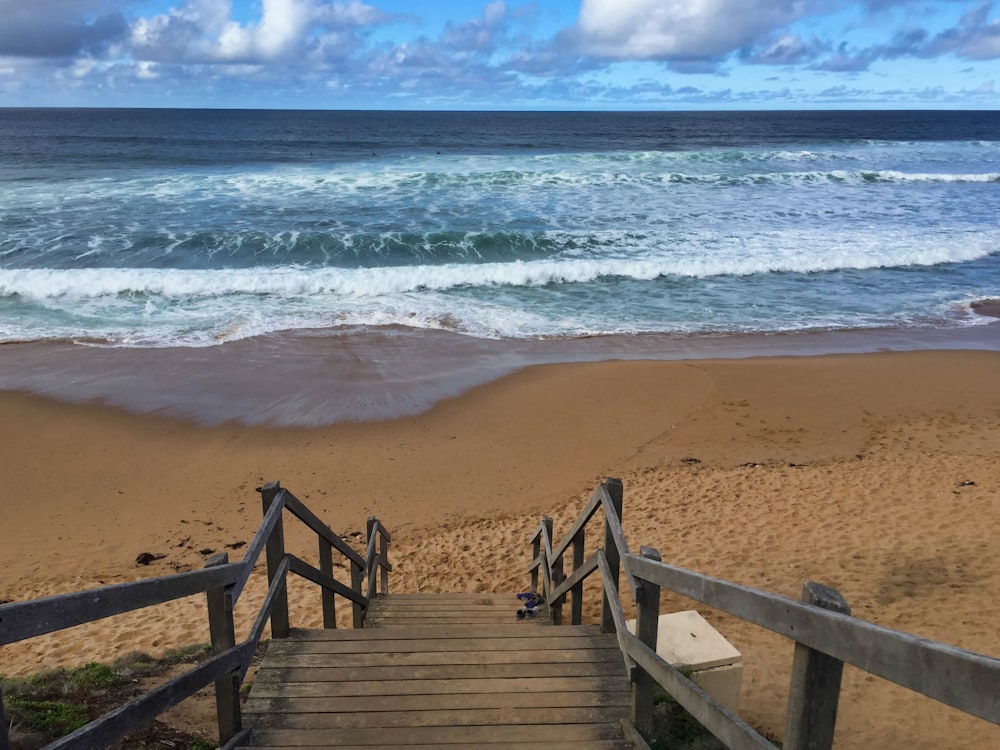 brown wooden dock on beach during daytime