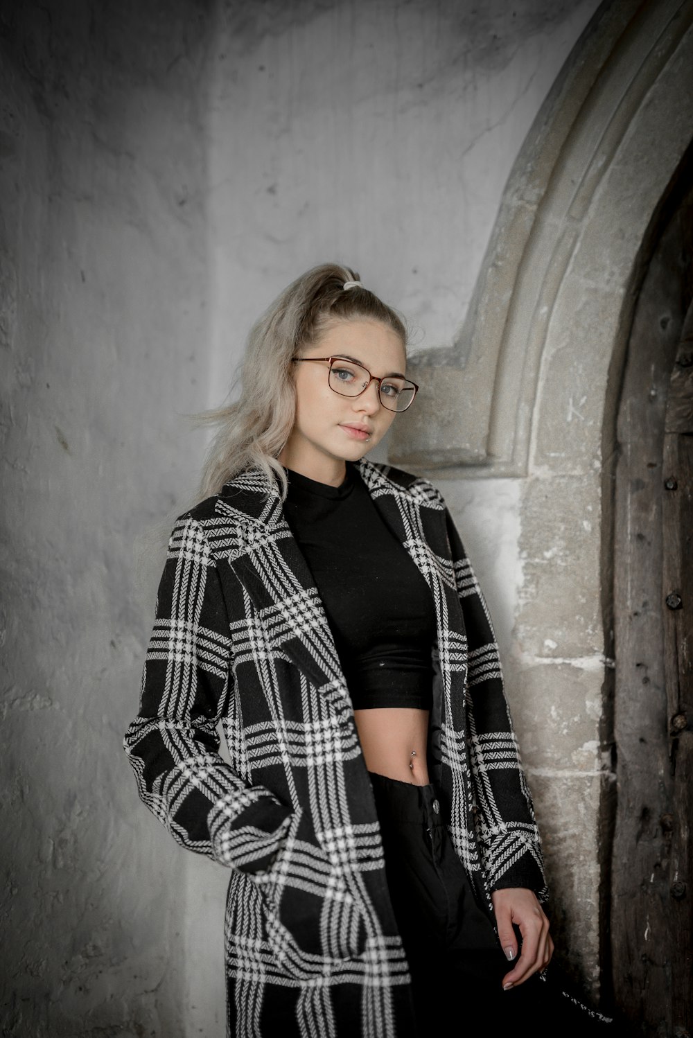 woman in black and white checkered dress shirt wearing black framed eyeglasses