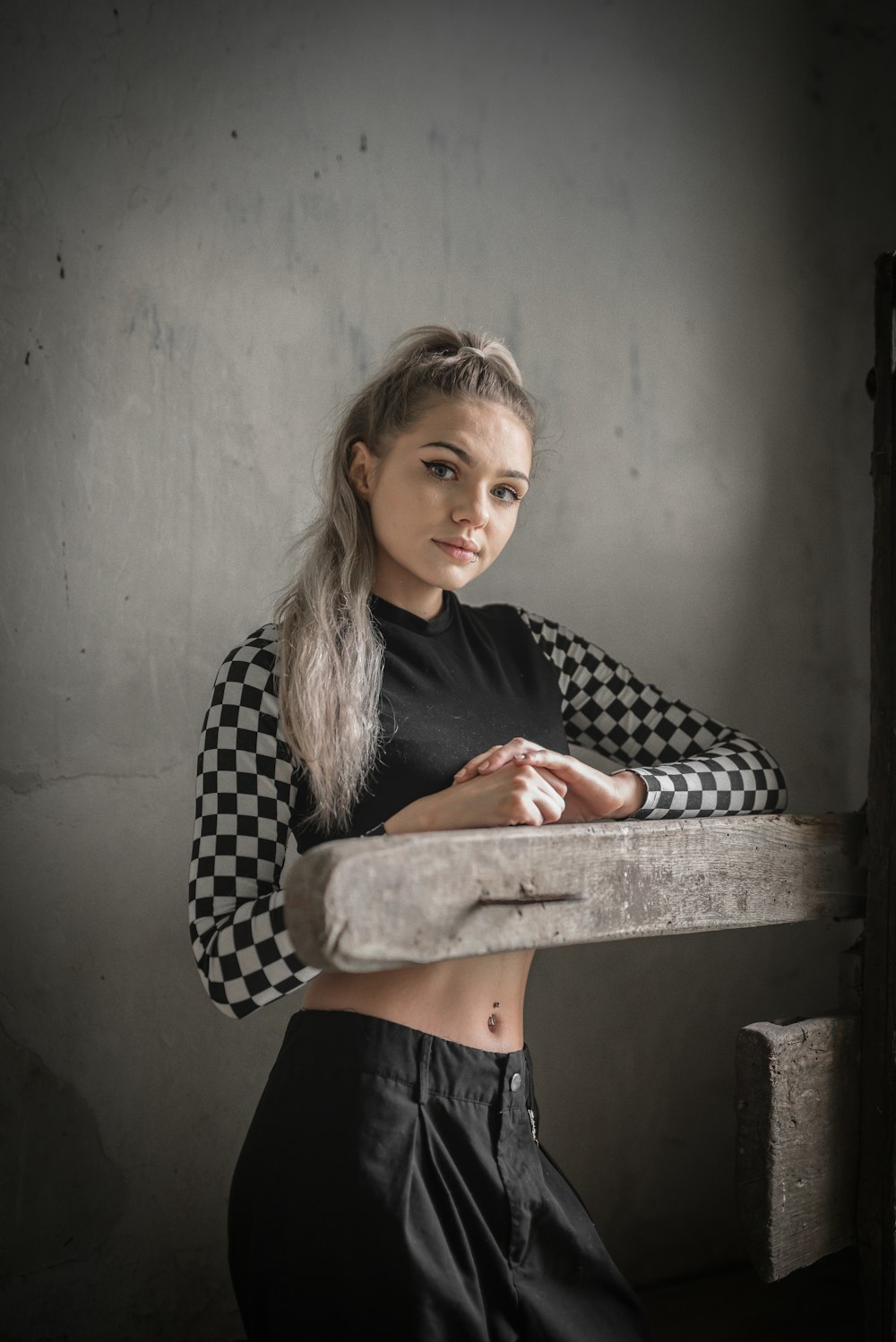 woman in black and white checkered long sleeve shirt sitting on chair