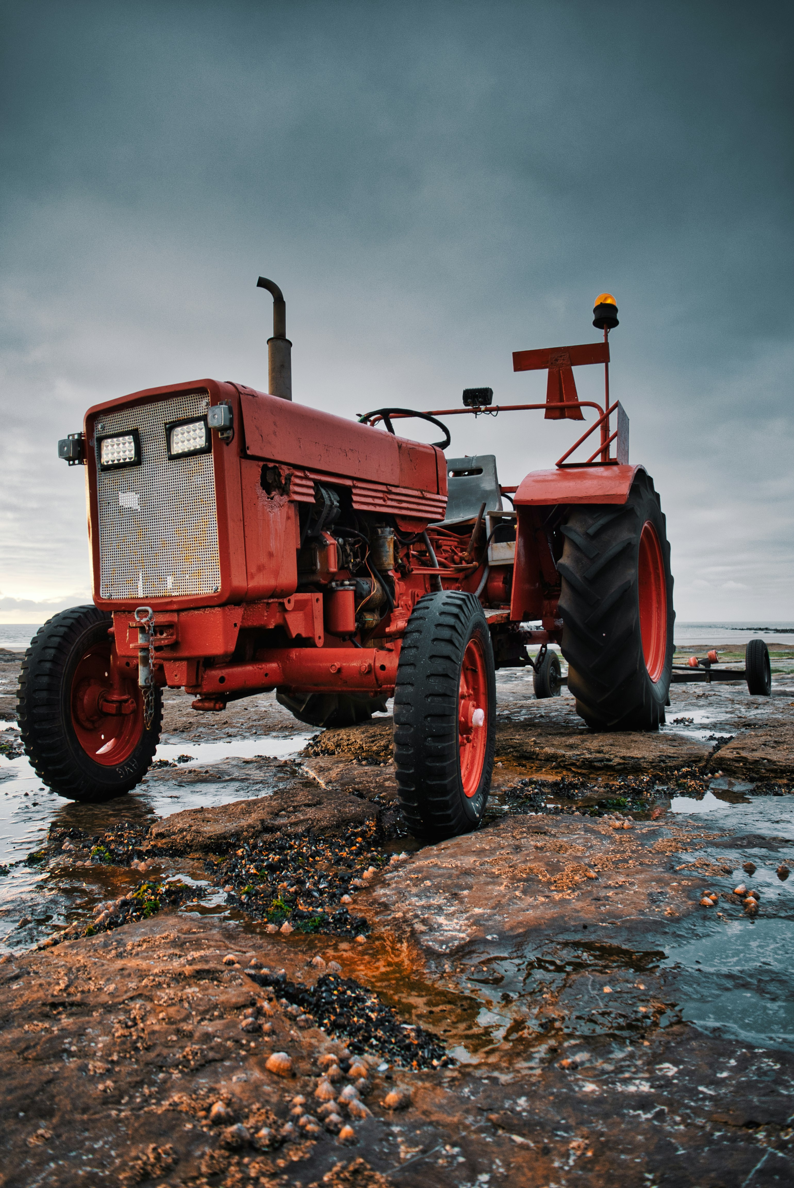 red tractor on brown soil