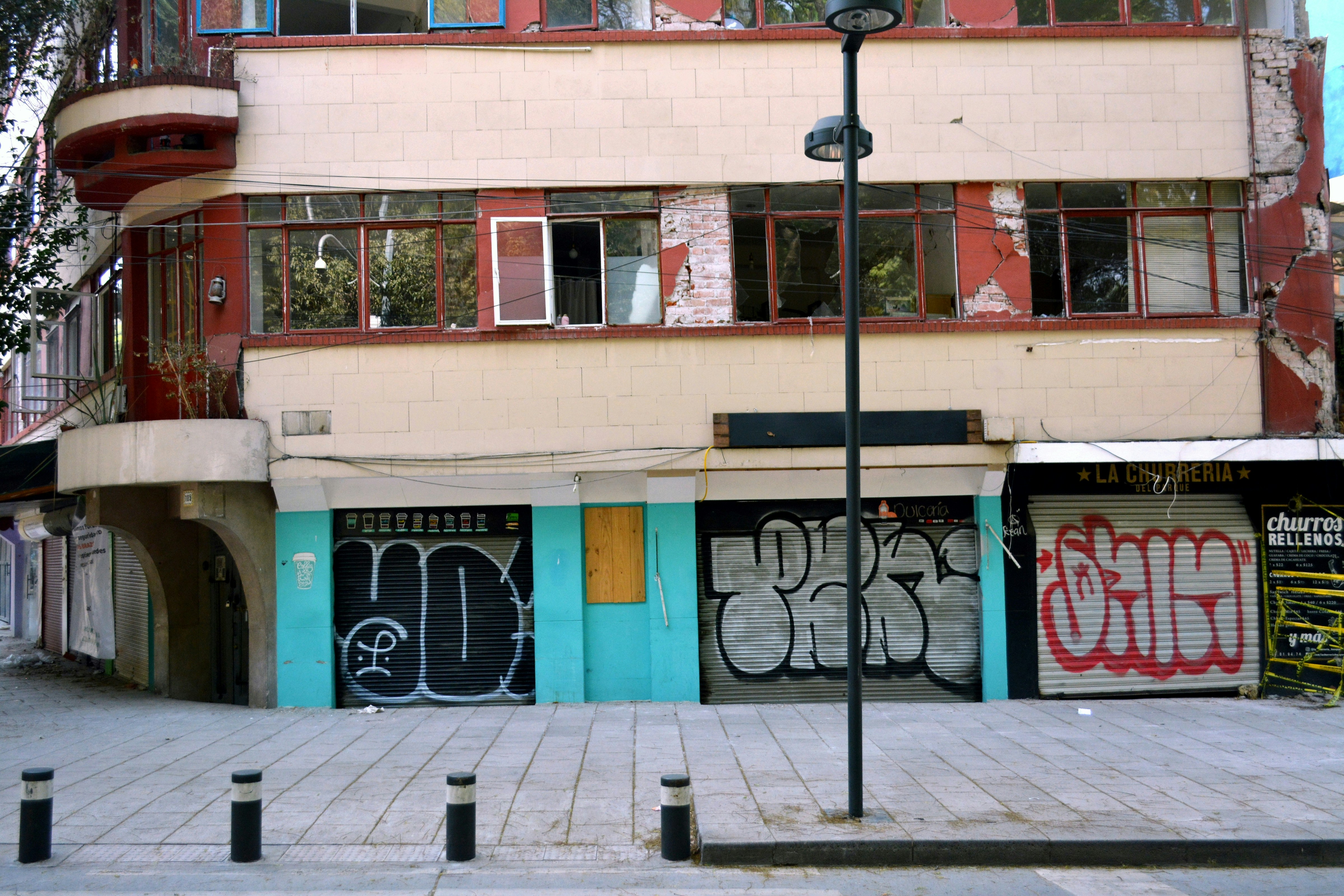 black metal street light near brown concrete building during daytime