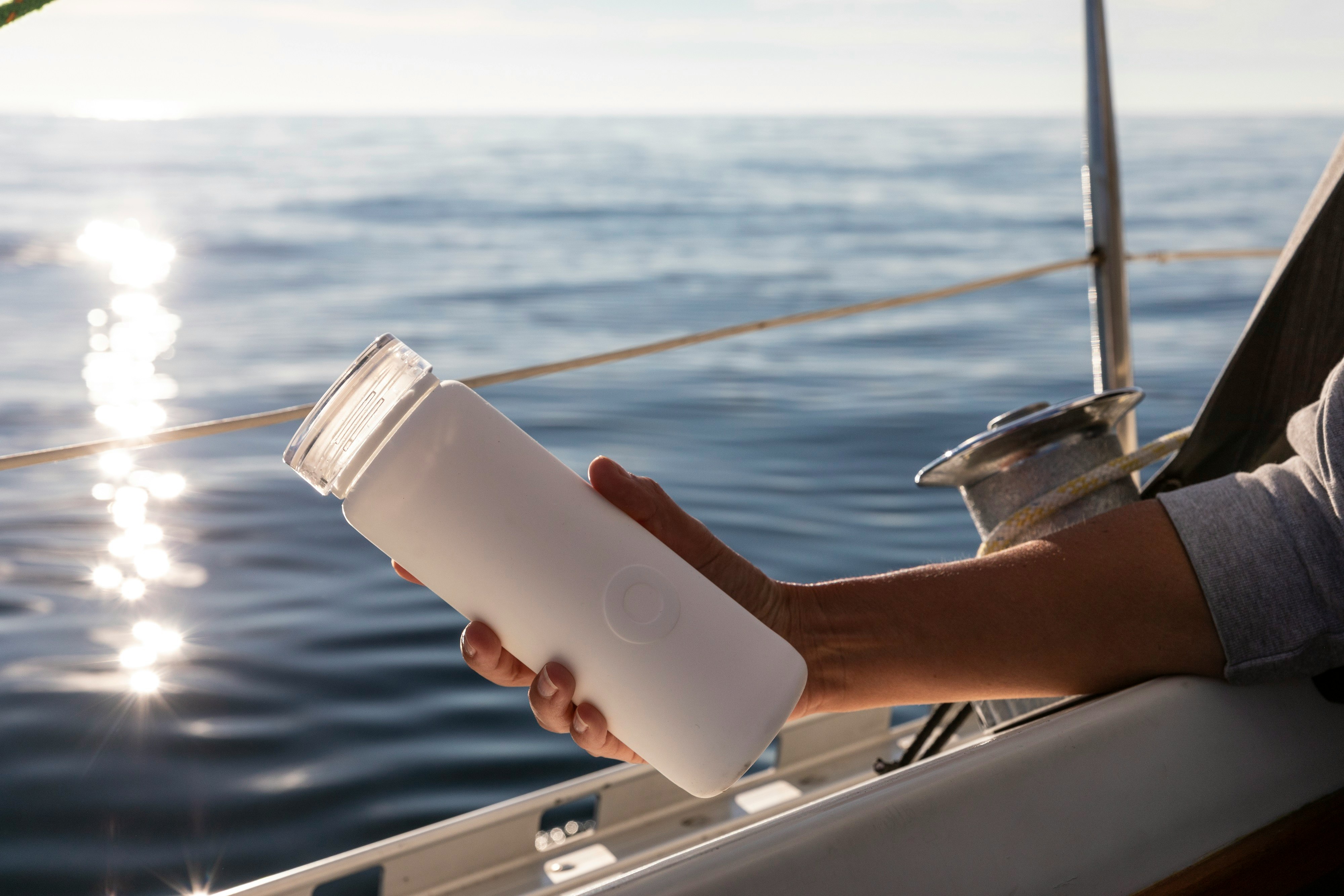 person holding white plastic cup