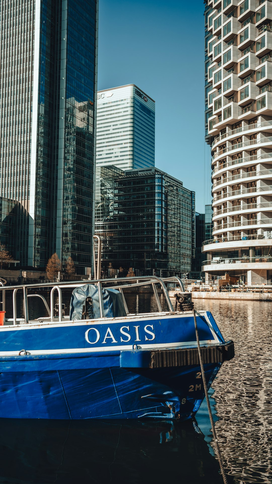 blue and white boat on water near city buildings during daytime