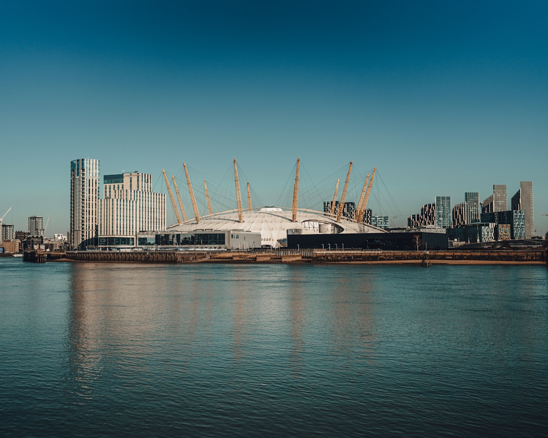 white and brown ship on sea near city buildings during daytime