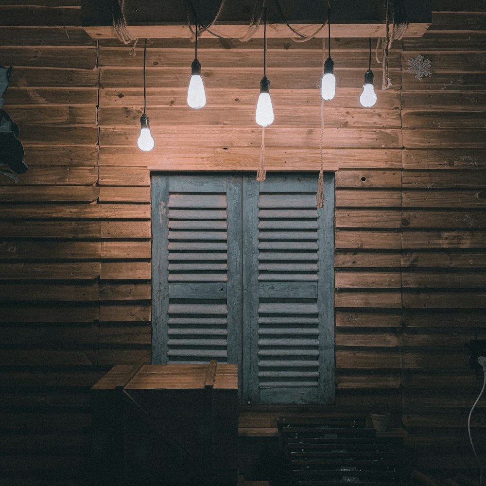 white pendant lamp turned on during daytime