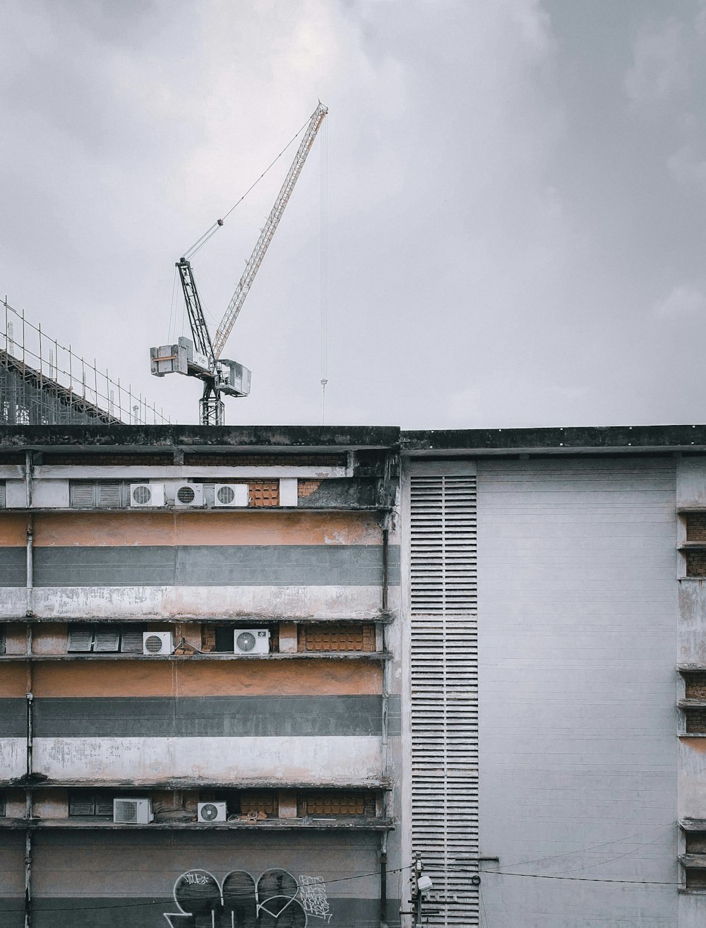 white and orange building under white clouds during daytime