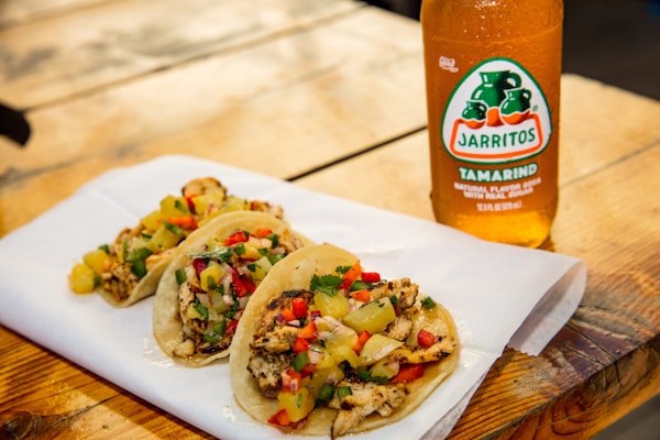 Taco sauce bottle on white ceramic plate