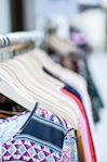 A vibrant display of colorful fashion apparel neatly arranged on hangers.