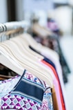 An array of clothing items neatly arranged on a wooden display.