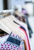 A collection of stylish clothing displayed on hangers.