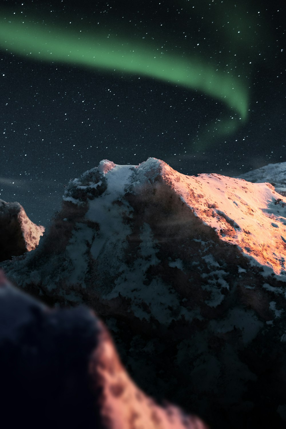 brown rock formation near body of water during night time