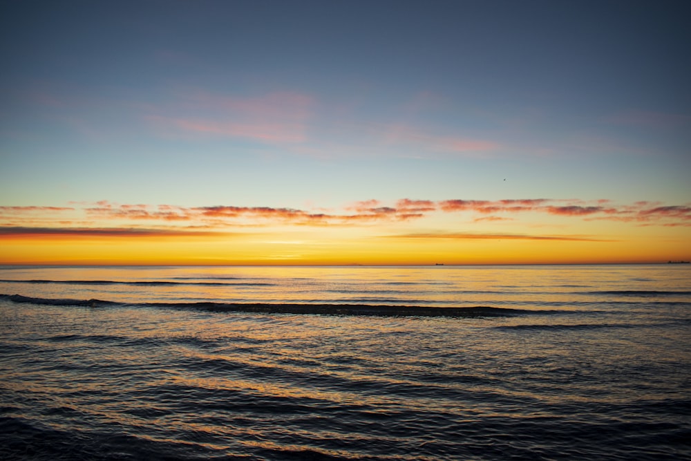 body of water during sunset