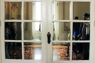 Elegant glass-paneled door reflecting a cozy interior.