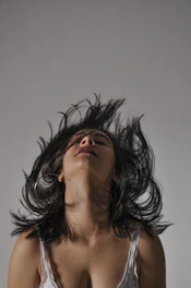 woman with black hair covering her face