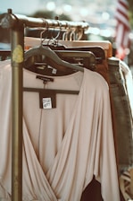 gray long sleeve shirt hanging on black clothes hanger