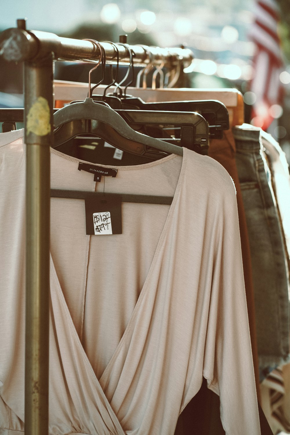 gray long sleeve shirt hanging on black clothes hanger